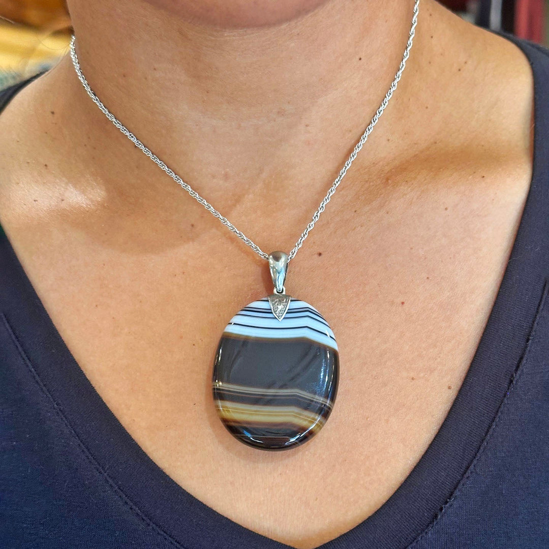 Natural banded agate gemstone pendant with engraved silver bale