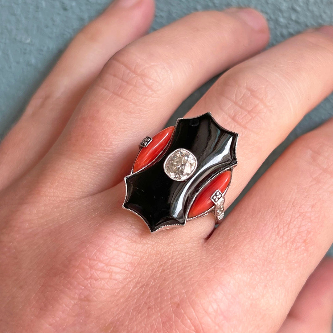 Close view of coral and onyx geometric ring