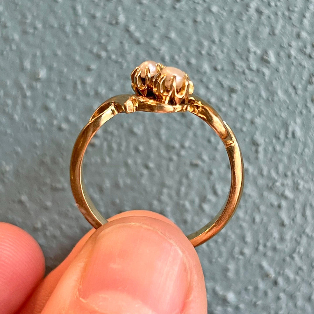 Side profile of antique bypass pearl ring