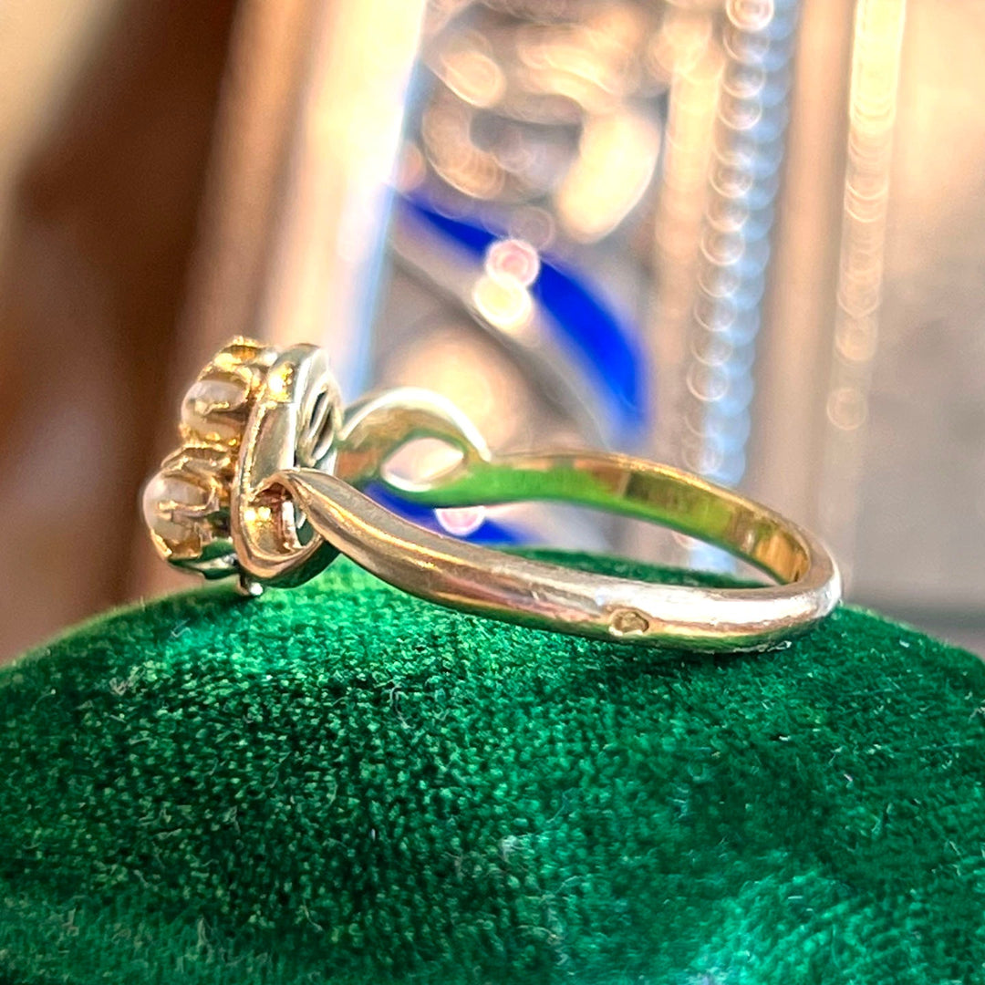 Side profile of antique bypass pearl ring