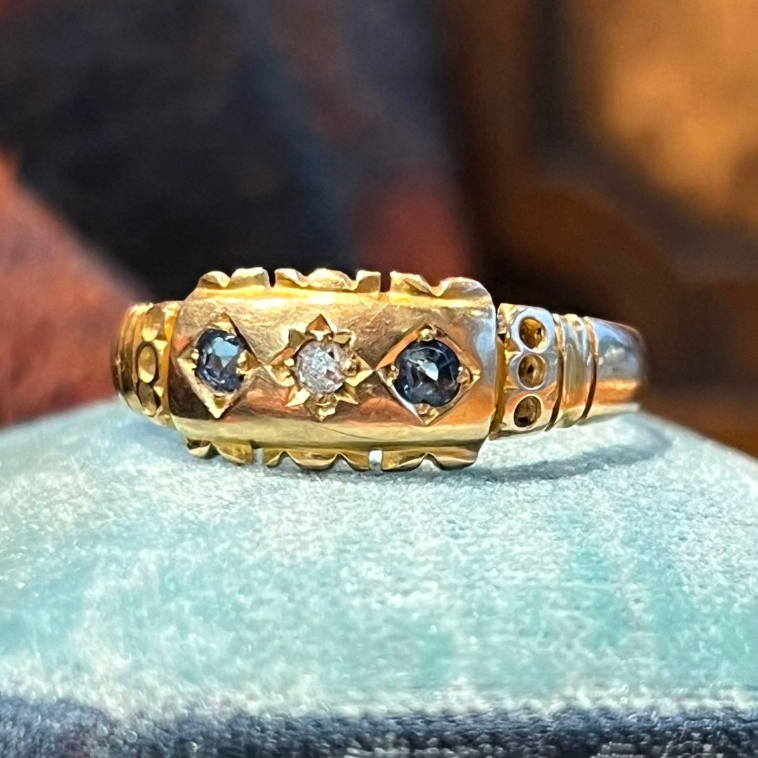 Vintage 1889 sapphire and diamond three stone ring close up