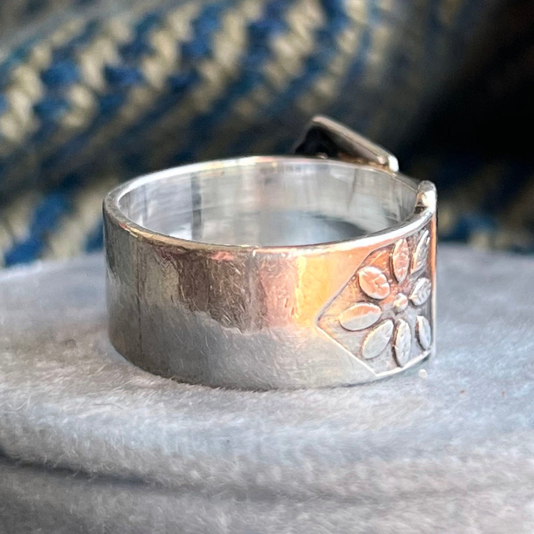 Close up engraved silver buckle ring detail