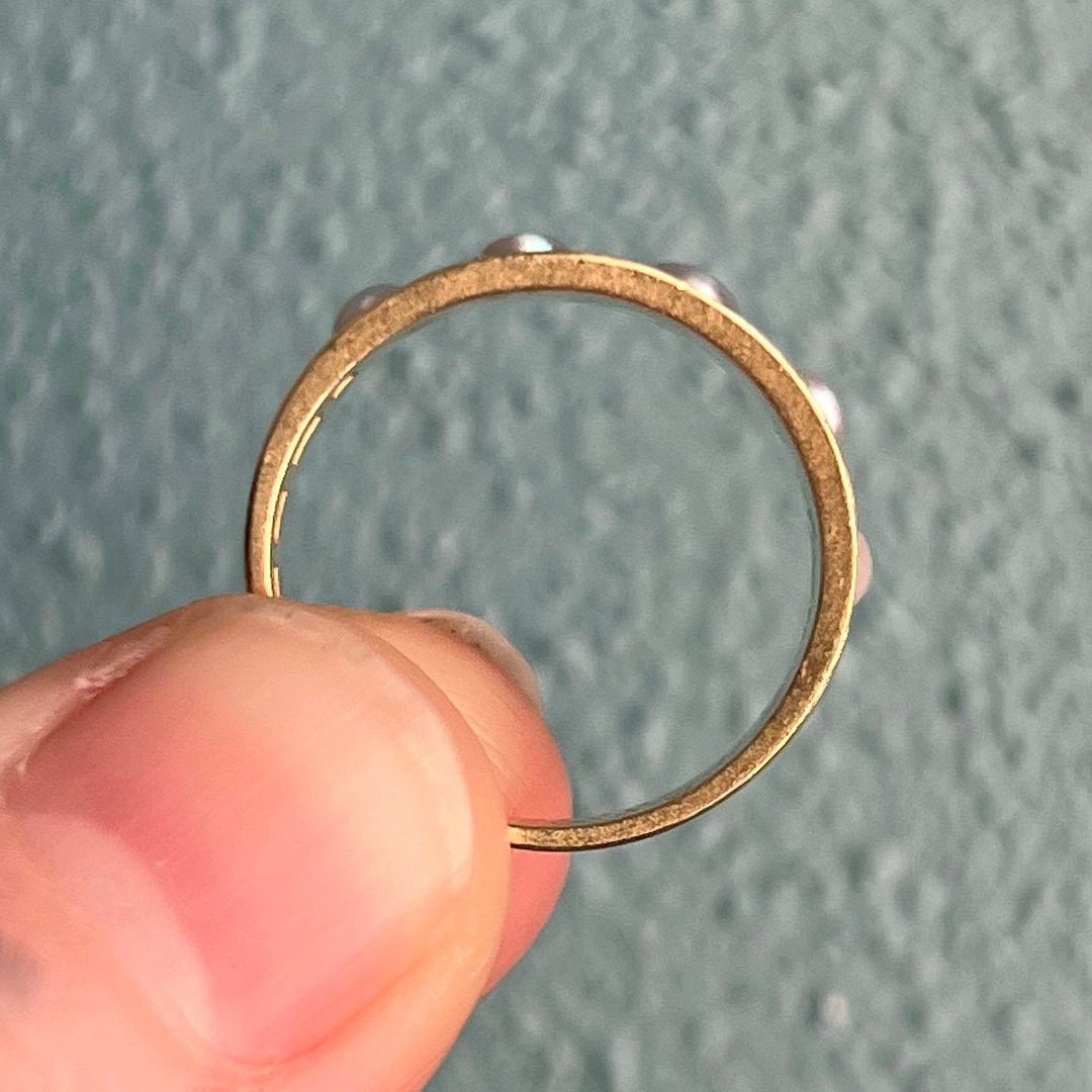 Side profile of five stone pearl ring