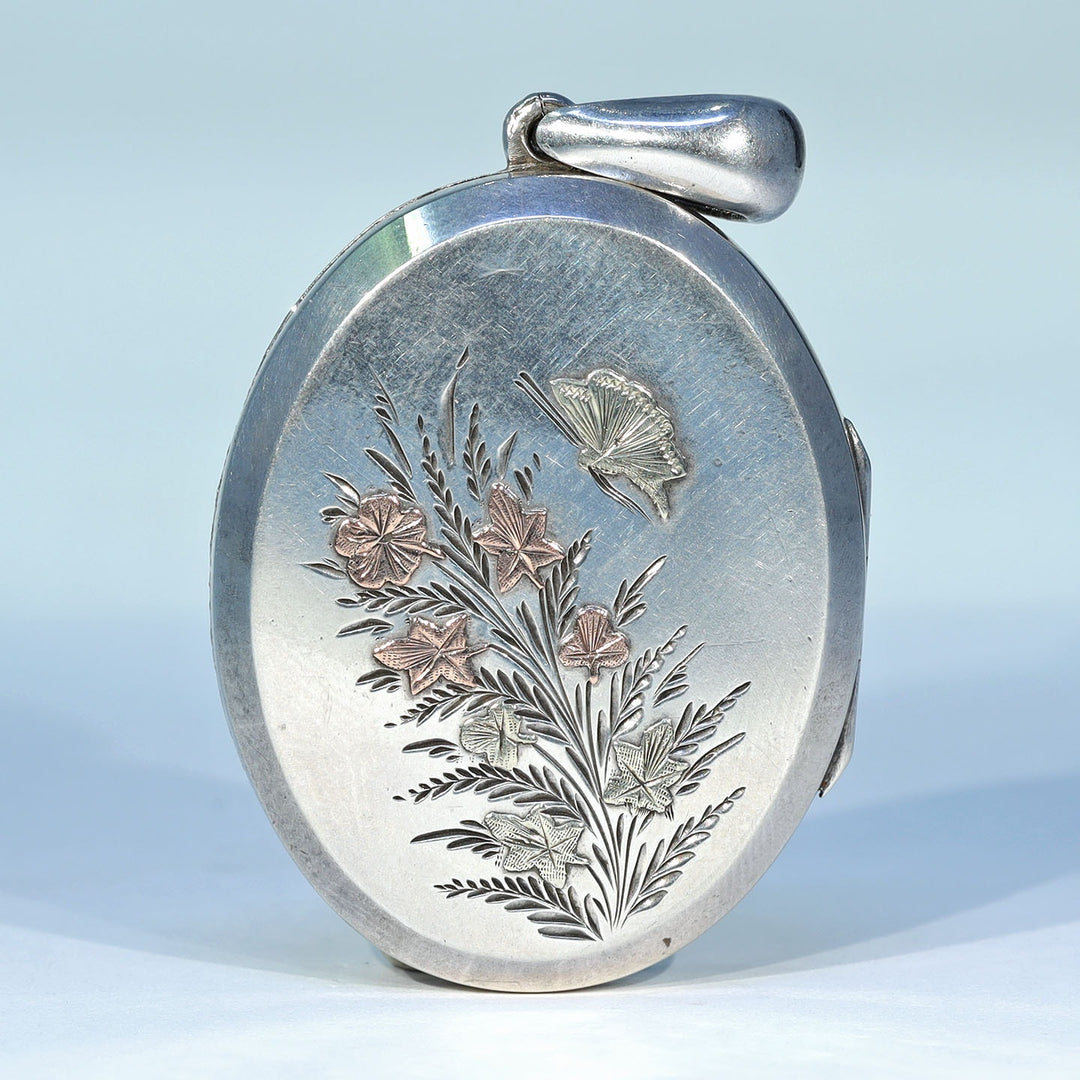 Victorian silver locket with butterfly and flower design