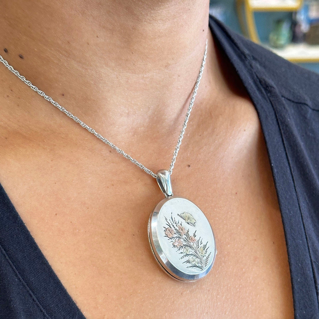 Victorian silver locket with butterfly and flower design