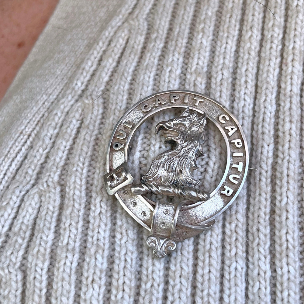 Antique heraldic silver brooch with engraved family crest