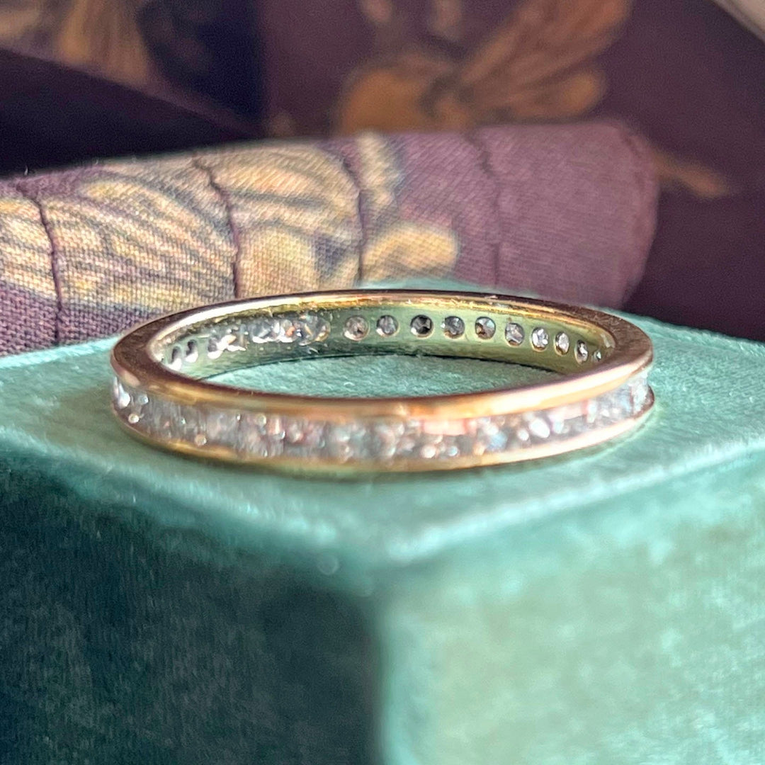 Gold eternity band with multiple diamonds close detail