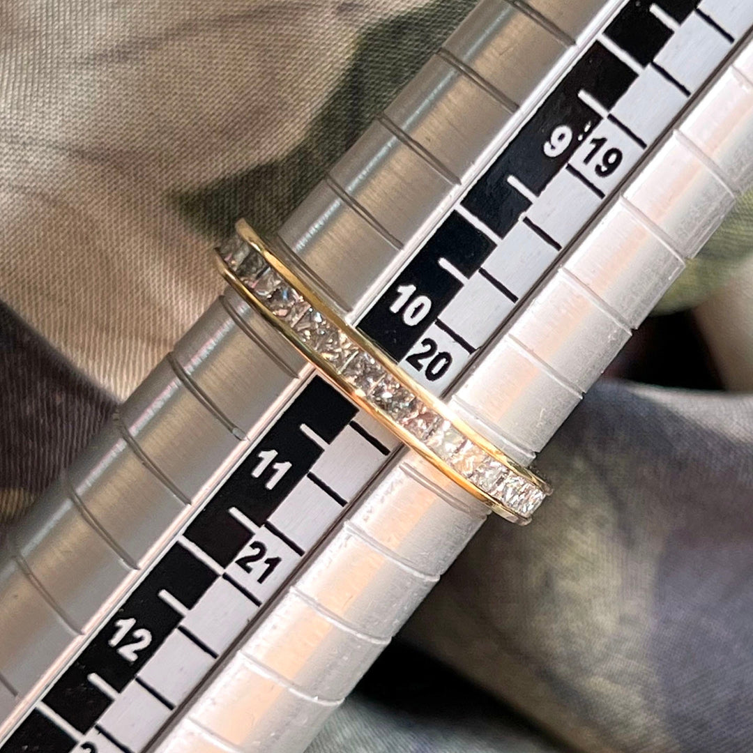 Gold eternity band with multiple diamonds close detail