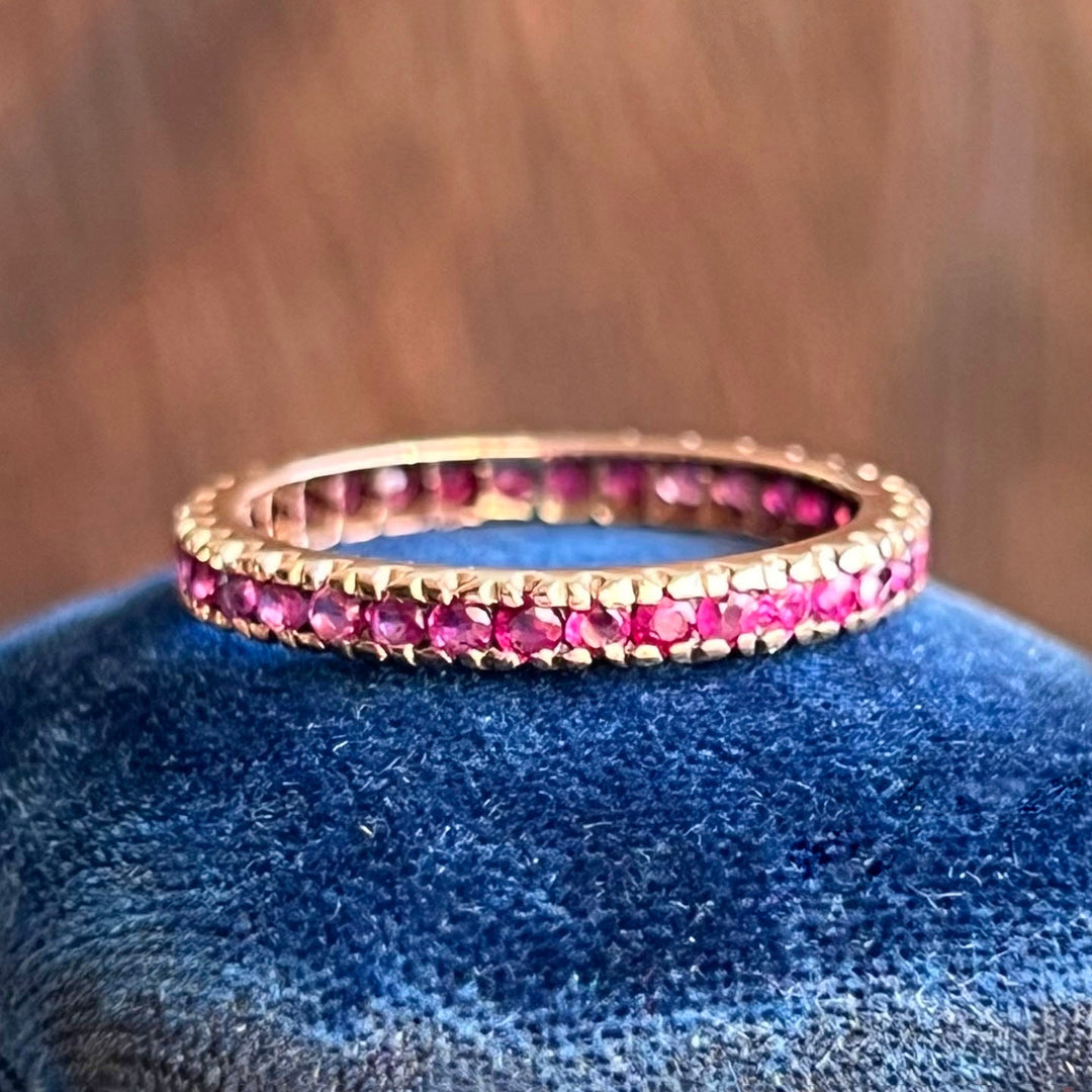 Gold band ring with continuous rubies