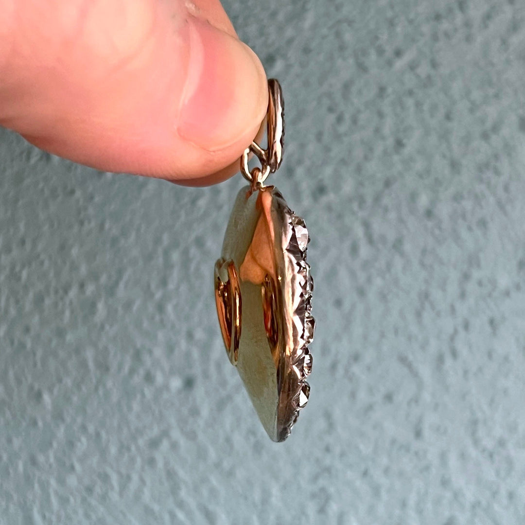 Side profile of gold diamond heart pendant
