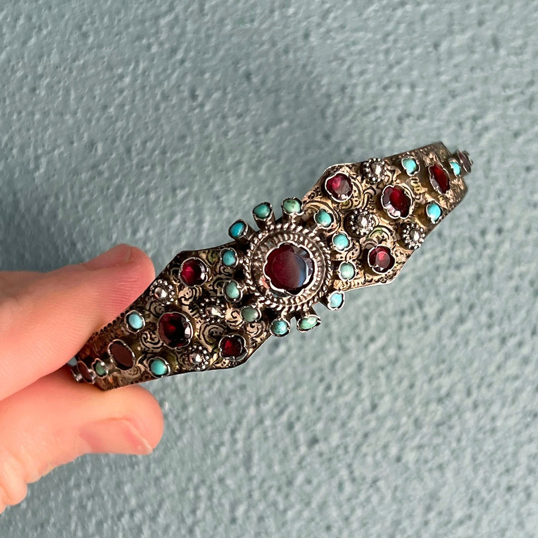 Close up turquoise and garnet gemstones silver bracelet