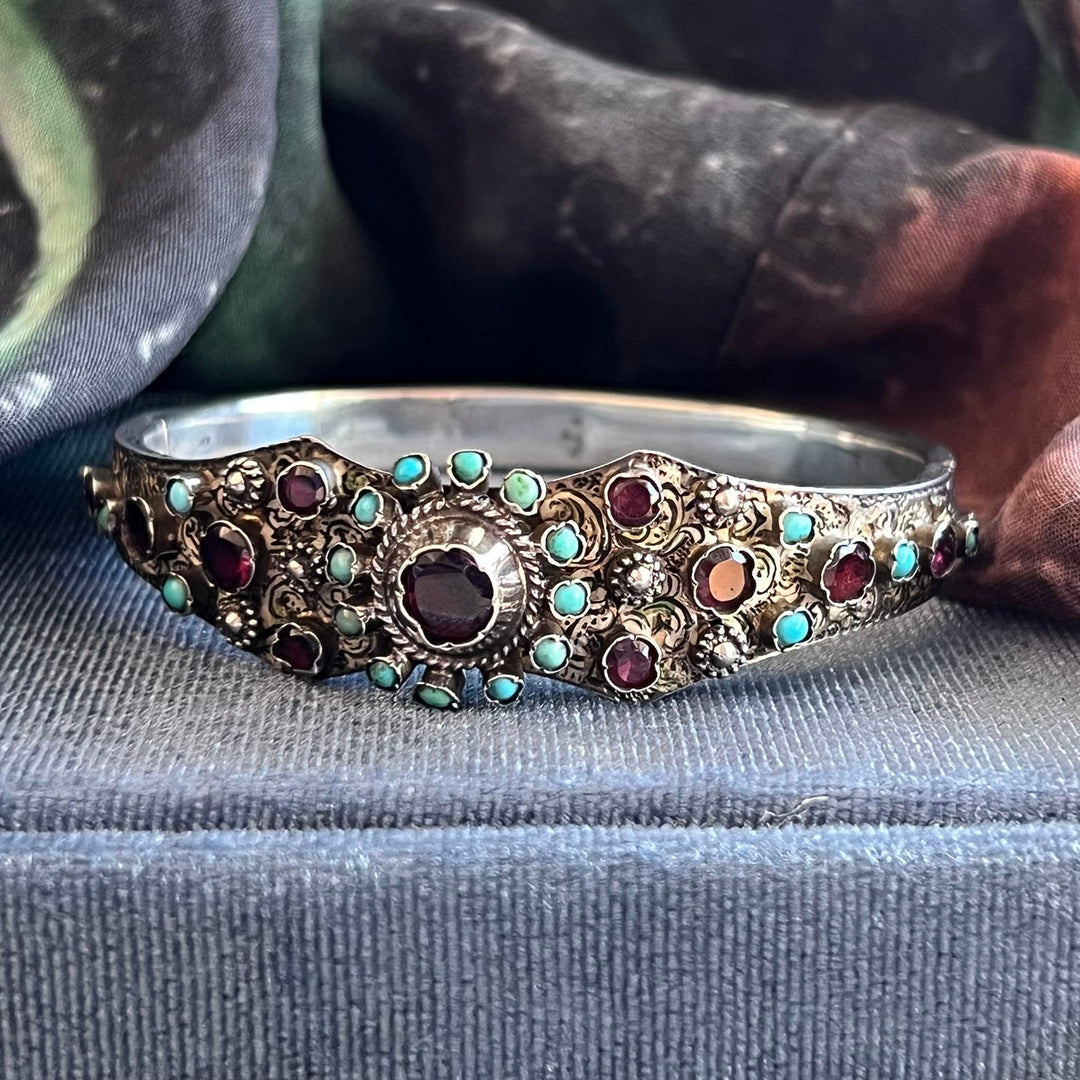 Close up turquoise and garnet gemstones silver bracelet