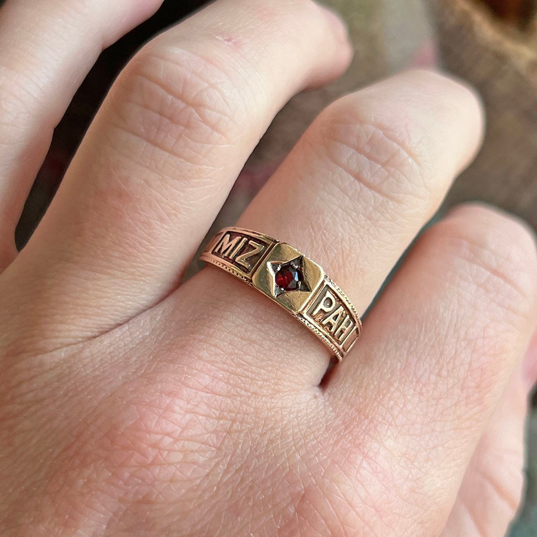 Vintage sentimental garnet ring on hand