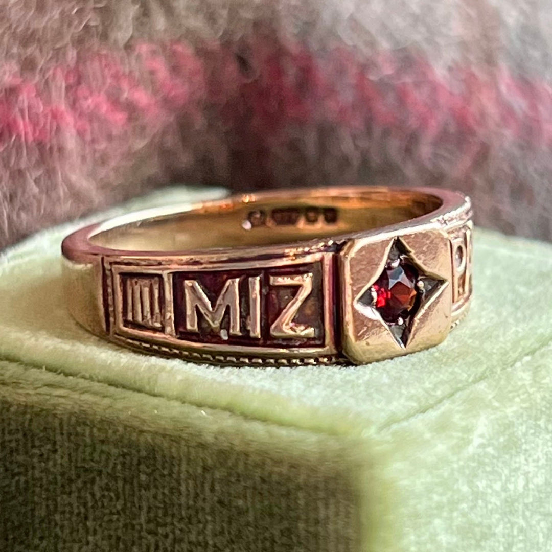 Mizpah garnet gold ring close up