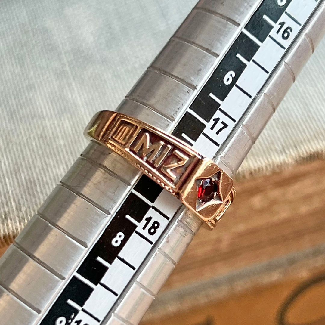 Close up vintage gold garnet Mizpah ring